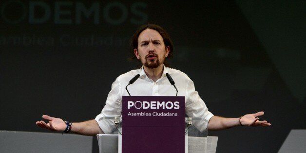 Newly confirmed leader of Podemos, a left-wing party that emerged out of the 'Indignants' movement, Pablo Igesias, gestures during a speech at a party meeting in Madrid on November 15, 2014. Podemos activists confirmed Pablo Iglesias, 36 years at the head of the movement, in a vote whose results were announced today. Pablo Iglesias was elected secretary general with 88.7% of the vote (95,311 votes out of 107,488) announced the party at a ceremony attended by nearly a thousand people in a Madrid theater. AFP PHOTO / DANI POZO (Photo credit should read DANI POZO/AFP/Getty Images)