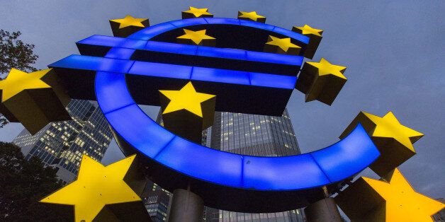 A euro sign sculpture stands illuminated in front of the European Central Bank (ECB) headquarters in Frankfurt, Germany, on Thursday, Oct. 23, 2014. At noon in Frankfurt on Oct. 26, investors will learn which of the currency bloc's 130 biggest banks fell short in the ECB's year-long examination of their asset strength and ability to withstand economic turbulence. Photographer: Martin Leissl/Bloomberg via Getty Images