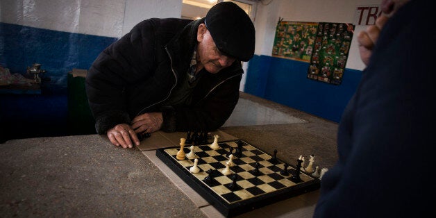 Tatars play chess within a market place in Bachisaray, a village with Tatar majority in Ukraine, Sunday, March 16, 2014. While Crimea's ethnic Russian majority may be in favor of joining Russia, the Tatars who were deported during World War II, fear that they will once again be unwelcome in their homeland. (AP Photo/Manu Brabo)