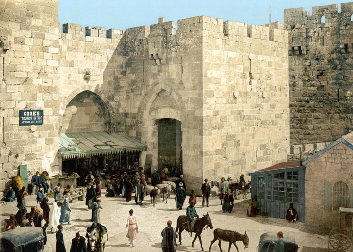 A Thomas Cook travel agent sign hangs on the Jaffa Gate in Jerusalem, 1910.