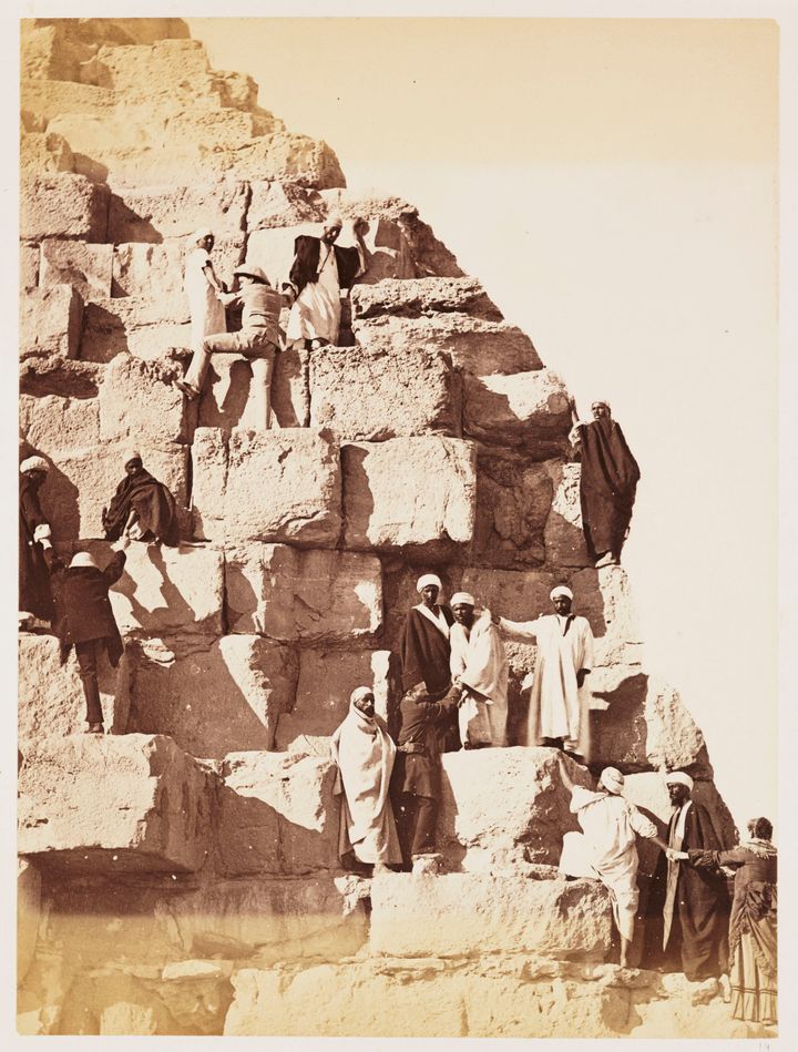 A group of European tourists climbing the Great Pyramid, taken in 1882 by an unknown photographer. Thomas Cook offered his first tour of Palestine and the Nile in 1869.