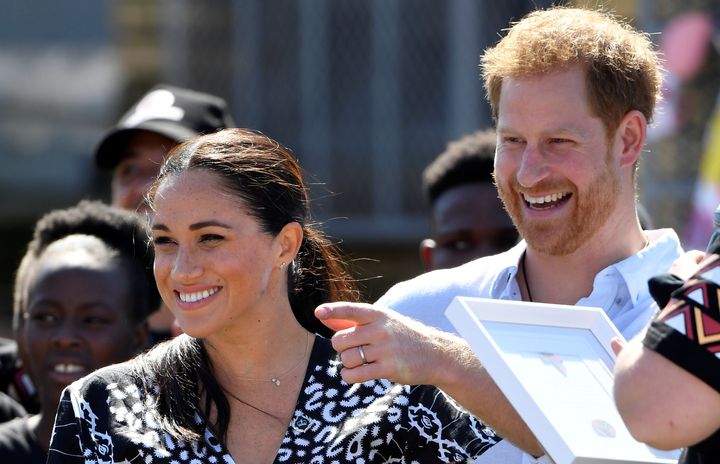 Prince Harry and his Meghan Markle smile during a stop on the first day of their African tour in Cape Town, South Africa, on Sept. 23.