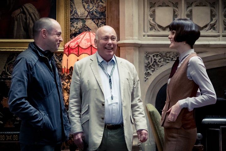 Producer Gareth Neame, writer and producer Julian Fellowes and actor Michelle Dockery on the set of "Downton Abbey," a Focus Features release.