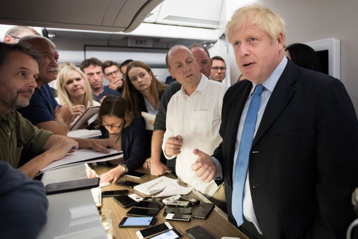 Prime Minister Boris Johnson talks to the media on board his plane as he flies to New York where he will attend the 74th Session of the UN General Assembly.