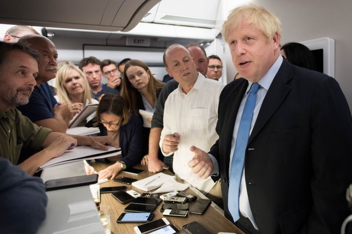 Prime Minister Boris Johnson talks to the media on board his plane as he flies to New York where he will attend the 74th Session of the UN General Assembly.