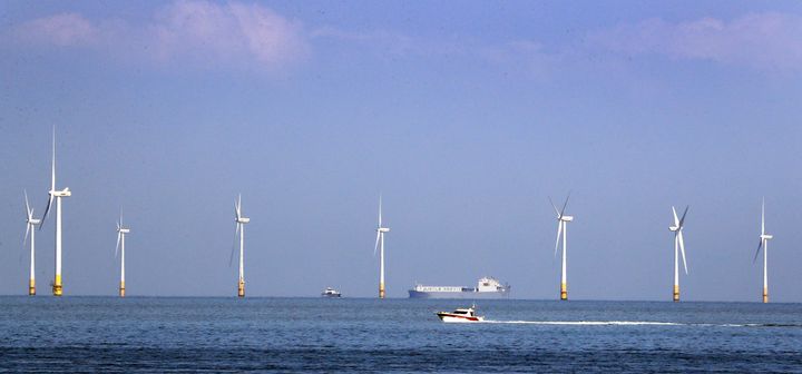 Boats pass the Kentish Flats Offshore Wind Farm