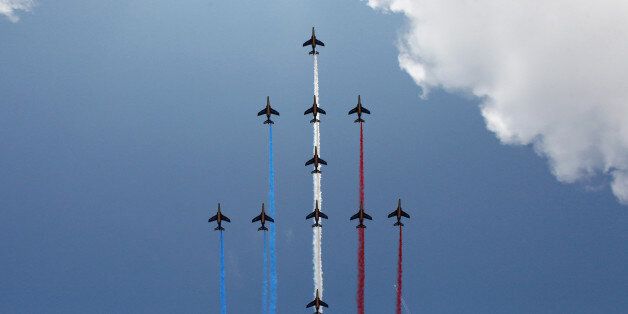 Jets of the Patrouille de France fly over the Champs Elysees avenue during the traditional Bastille Day parade in Paris, France, Tuesday, July 14, 2015. French anti-terrorist forces join the traditional military parade celebrating Bastille Day, as the country's leadership tries to show its muscle against extremists abroad and at home. Mexico's president is the guest of honor at this year's event marking France's biggest holiday. (AP Photo/Thibault Camus)