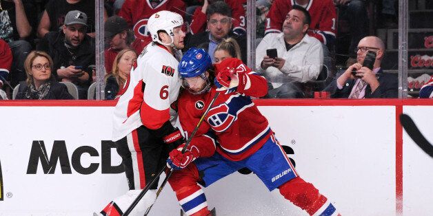 MONTREAL, QC - APRIL 15: Bobby Ryan #6 of the Ottawa Senators and Tom Gilbert #77 of the Montreal Canadiens battle for the puck during Game One of the Eastern Conference Quarterfinals during of the 2015 NHL Stanley Cup Playoffs at the Bell Centre on April 15, 2015 in Montreal, Quebec, Canada. The Canadiens defeated the Senators 4-3. (Photo by Richard Wolowicz/Getty Images)
