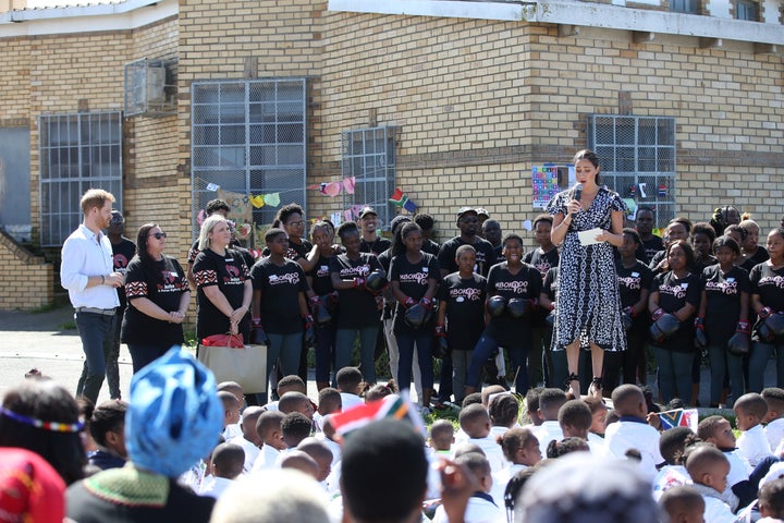 Harry looks on as Meghan speaks during the Justice Desk initiative in Nyanga township, on the first day of their African tour in Cape Town. 