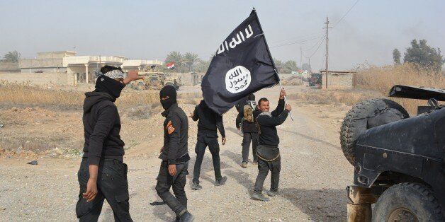Iraqi government forces celebrate while holding an Islamis Sate (IS) group flag after they claimed they have gained complete control of the Diyala province, northeast of Baghdad, on January 26, 2015 near the town of Muqdadiyah. Iraqi forces have 'liberated' Diyala province from the Islamic State jihadist group, retaking all populated areas of the eastern region, a top army officer said today. The symbolic victory for Baghdad, which has at times struggled to push IS back, could clear the way for further advances against the jihadists . AFP PHOTO / YOUNIS AL-BAYATI (Photo credit should read YOUNIS AL-BAYATI/AFP/Getty Images)