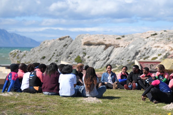 The Duke and Duchess of Sussex participate in a group meditation session.