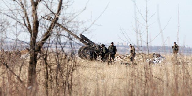 Ukrainian artillery is at a position outside of the village of Luhanske, some 20 kilometers (14 miles) north of Debaltseve, Ukraine, Tuesday, Feb. 17, 2015. Ukrainian government troops and Russia-backed rebels failed Tuesday to start pulling back heavy weaponry from the front line in eastern Ukraine as a deadline passed to do so. Under a cease-fire agreement negotiated by the leaders of Ukraine, Russia, Germany and France last week, the warring sides were to begin withdrawing heavy weapons from the front line on Tuesday. (AP Photo/Petr David Josek)