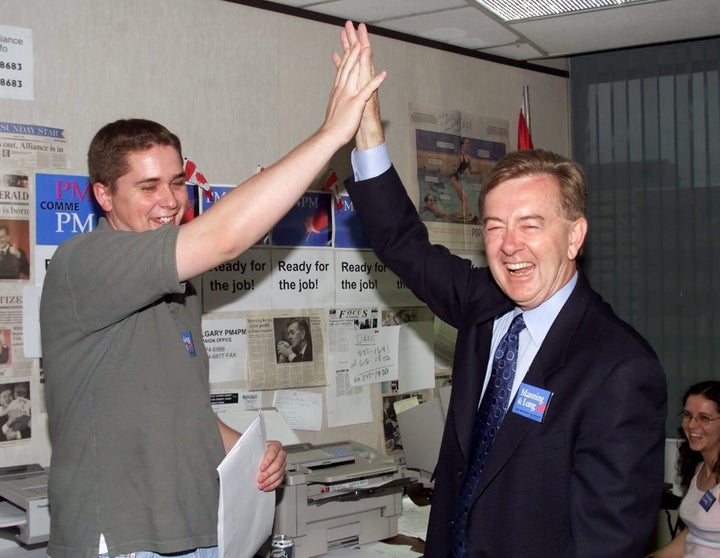 Canadian Alliance candidate Preston Manning gives a high five to Andrew Scheer of the University of Ottawa Canadian Alliance Club during a stop in the Manning campaign headquaters in Ottawa on July 3, 2000.