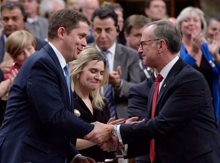 Conservative Leader Andrew Scheer shakes hands with Liberal MP Rob Oliphant (right) after Scheer's speech in the House of Commons on Nov. 28, 2017 following a formal apology to individuals harmed by federal legislation, policies, and practices that led to the oppression of and discrimination against LGBTQ2 people in Canada. 