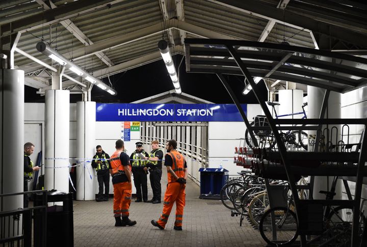 Police outside Hillingdon underground station in London, where a murder investigation has been launched after a man was stabbed to death.