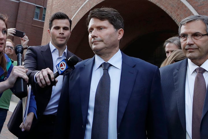 Devin Sloane, middle, leaves federal court after his sentencing in a nationwide college admissions bribery scandal, Tuesday, Sept. 24, 2019, in Boston.