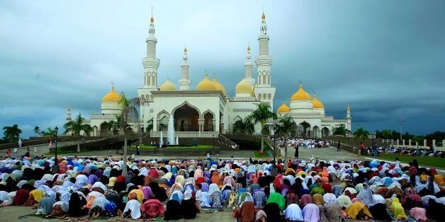 CORRECTION - Filipino Muslims participate in morning prayers as they celebrate Eid al-Fitr at the Sultan...