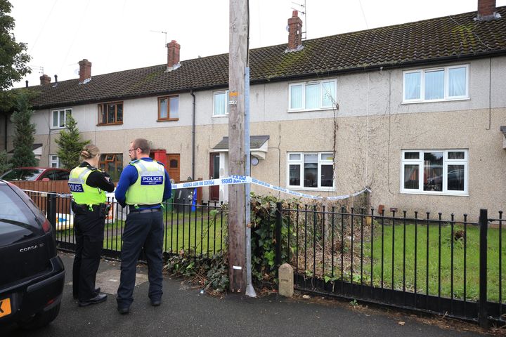 Police officers at a property on Graham Road in Widnes in Cheshire, after a woman died after being attacked by two dogs on Tuesday evening