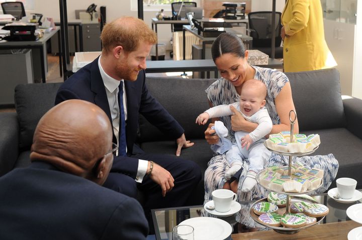 Meghan holds their baby son Archie as they meet with Archbishop Desmond Tutu at the Tutu Legacy Foundation in Cape Town on Sept. 25.