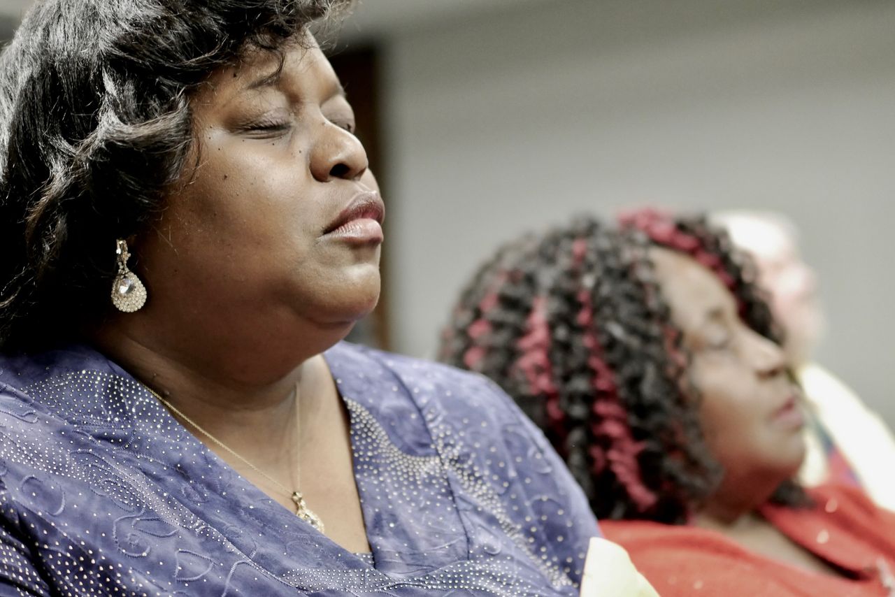Activist Keisha Brown prays during a meeting at the Alabama Department of Environmental Management.