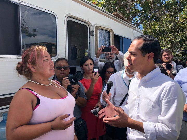 Julián Castro speaks with Maria Fuentes, a homeless resident at an encampment in Oakland.