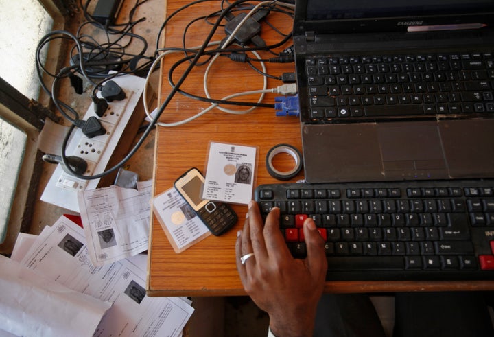 An operator works on his table while enrolling villagers for the Unique Identification (UID) database system at an enrolment centre at Merta district in the desert Indian state of Rajasthan February 21, 2013.