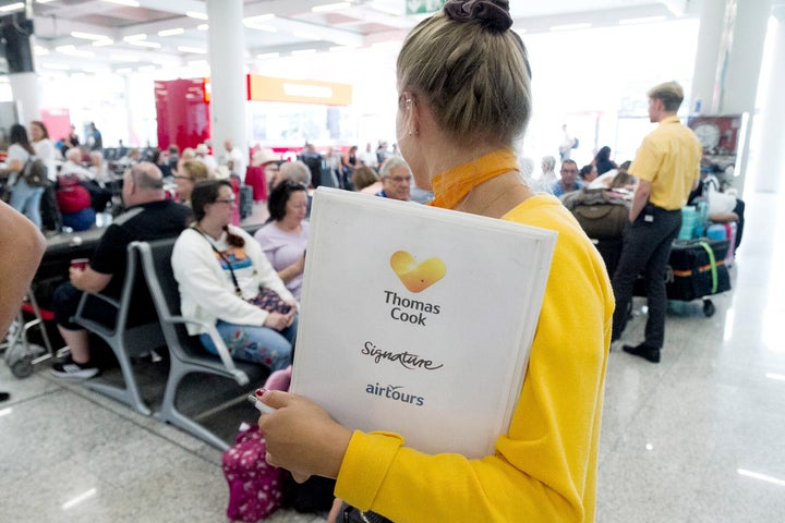 Thomas Cook staff giving information to British passengers at Palma de Mallorca airport on Monday. 