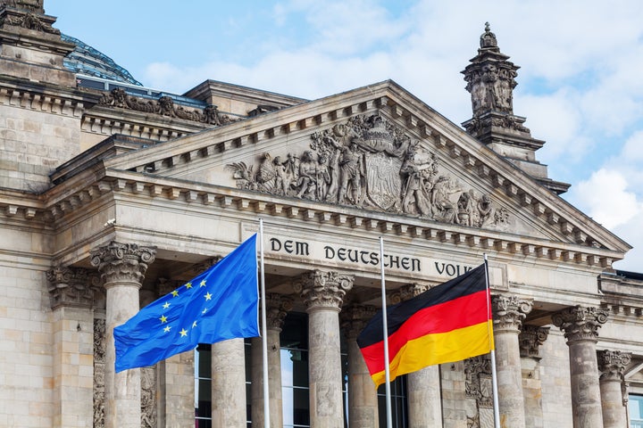 German Reichstag in Berlin, Germany, with national flag