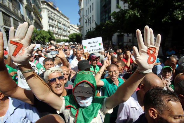 A demonstrator raises chained hands during a protest demanding social and economic reforms, as well as...