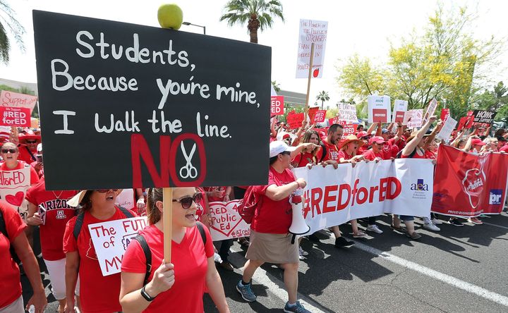 Arizona teachers march through downtown Phoenix on their way to the State Capitol as part of a rally for the #REDforED movement on April 26, 2018 in Phoenix, Arizona. 