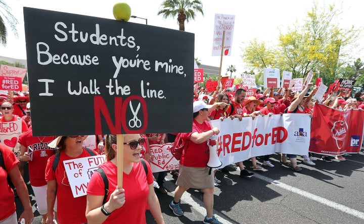 Arizona teachers march through downtown Phoenix on their way to the State Capitol as part of a rally for the #REDforED movement on April 26, 2018 in Phoenix, Arizona. 