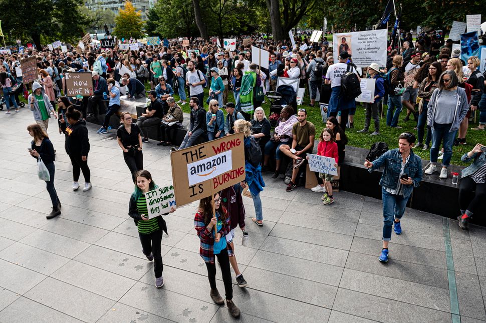 "The wrong Amazon is burning," reads a sign at a climate protest in Toronto on Sept. 27, 2019, in reference to forest fires that have burned through the Amazon rainforest in Brazil.