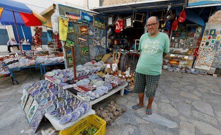 Ridha, a shopkeeper waits for customers in front of a souvenir shop following Thomas Cook's collapse, in Hammamet, Tunisia.