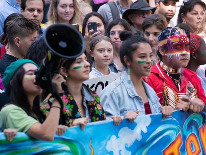 Swedish activist and student Greta Thunberg, centre, takes part in the Climate Strike in Montreal on Friday.
