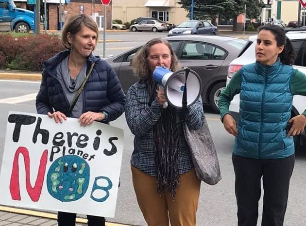 Three people protest to demand action on climate change in Terrace, B.C. on Sept. 20,