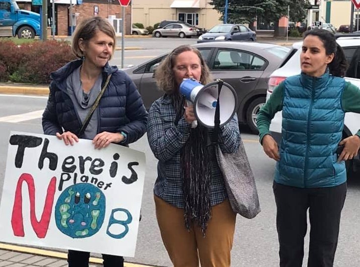 Three people protest to demand action on climate change in Terrace, B.C. on Sept. 20, 2019.