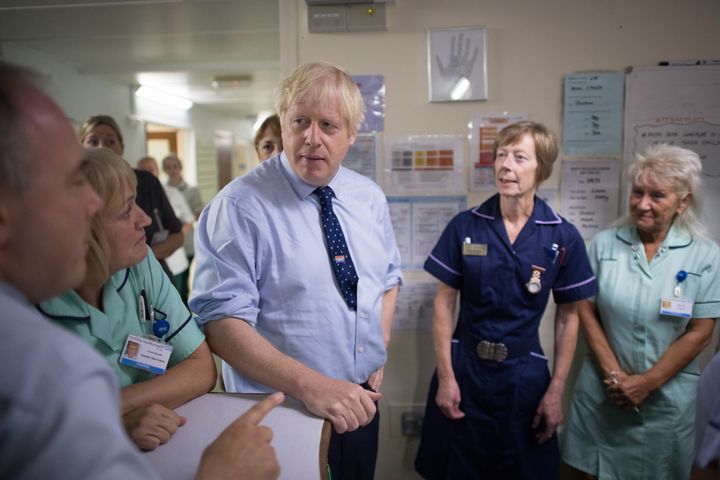 Prime Minister Boris Johnson meets staff during a visit to The Princess Alexandra hospital in Harlow, Essex on Friday. 