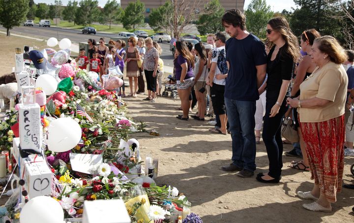 Christian Bale, the star of "The Dark Knight Rises," and his wife Sibi Blazic visit a memorial to the victims of the mass shooting in Aurora, Colo. 