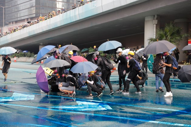 Police spray blue colored water on protestors Hong Kong, Sunday, Sept. 29, 2019. (AP Photo/Vincent Thian)