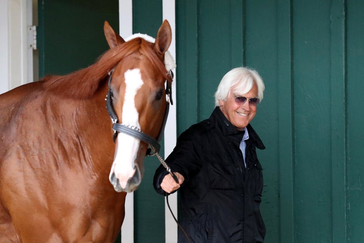 Trainer Bob Baffert walks Kentucky Derby winner Justify in the barn ahead of last year's Preakness Stakes in Baltimore.