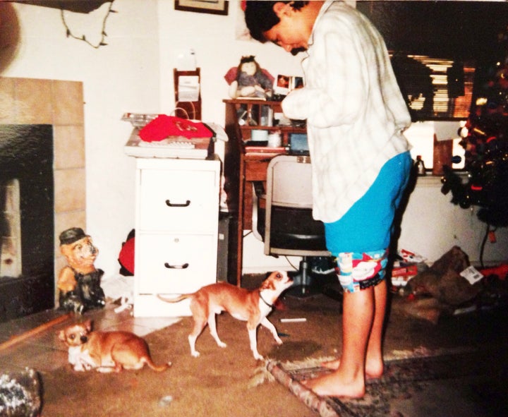 Me standing in our putrid living room with some of our chihuahuas. I loved them so much despite their waste that littered the