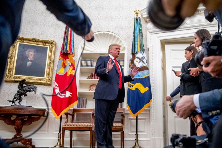 President Donald Trump stops to take a question from NBC Chief White House Correspondent Hallie Jackson, right, as he departs a ceremonial swearing in ceremony for new Labor Secretary Eugene Scalia on Monday, Sept. 30, 2019.
