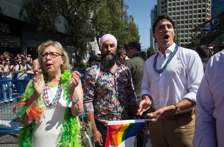 Liberal Leader Justin Trudeau, right, cheers while waiting to march in the Vancouver Pride Parade with Green Party Leader Elizabeth May, left, and NDP Leader Jagmeet Singh, centre, in Vancouver, on Sunday August 4, 2019. 