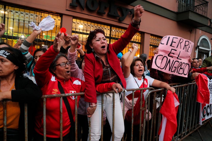 Demonstrators who had gathered to protest lawmakers pushing forward a vote to select an almost-full slate of new magistrates to the Constitutional Tribunal, celebrate after President Martin Vizcarra dissolved the legislature in Lima, Peru, Monday, Sept. 30, 2019.