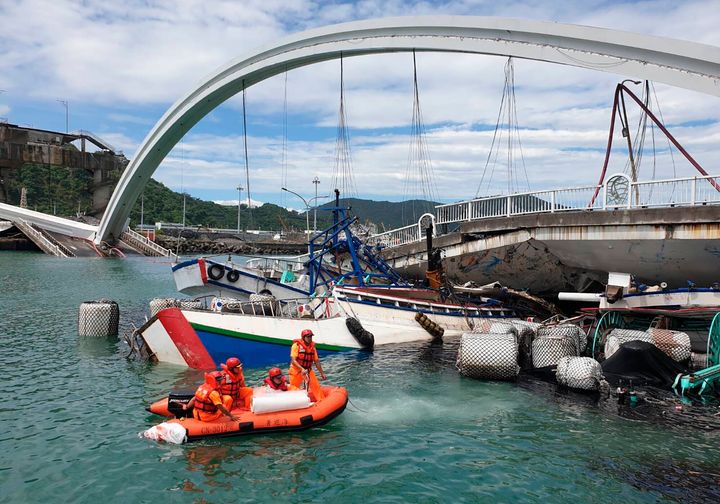 Rescuers work near the site of a collapsed bridge in Nanfangao, eastern Taiwan. Tuesday, Oct. 1, 2019. 