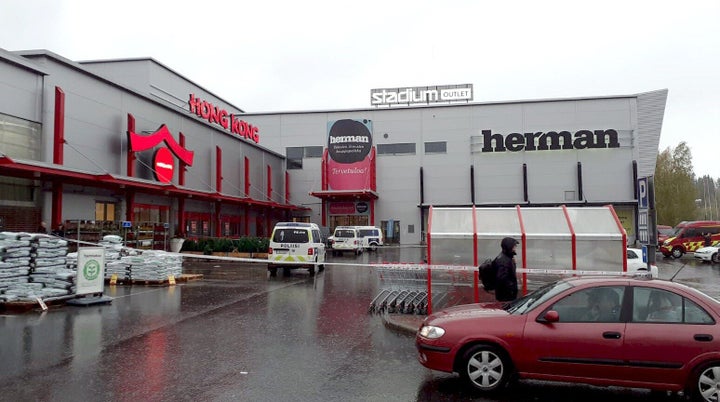 Police cars stand on the blocked grounds of the Hermanni shopping centrer in Kuopio, Finland, after an attack occurred on the