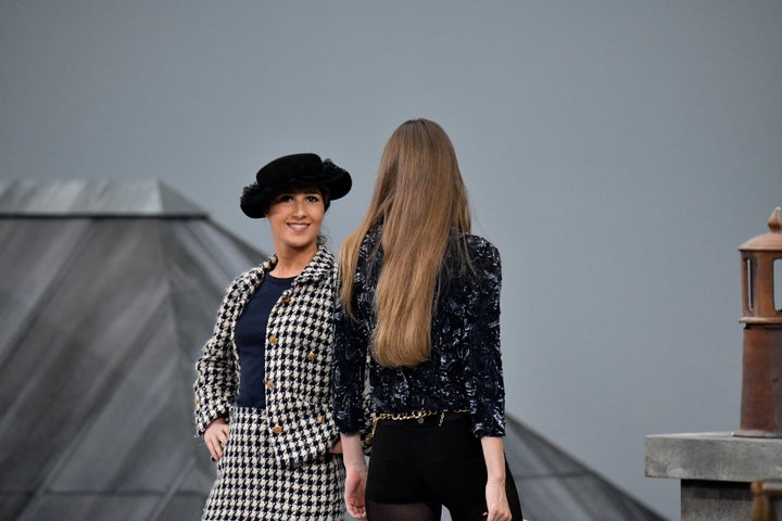 Gigi Hadid approaches the woman during the finale and escorts her off the catwalk.