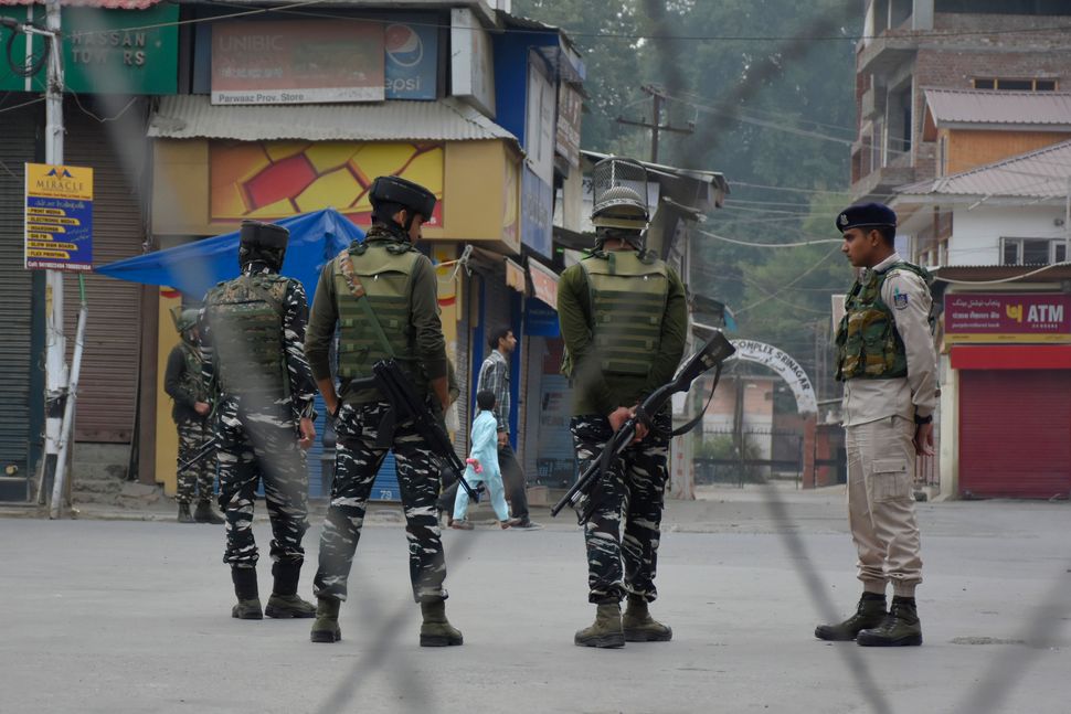 Indian forces stand alert during restrictions in Srinagar, Jammu and Kashmir on 27 September 2019. 