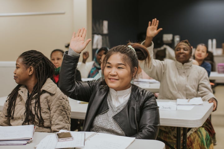A photo shows refugees and immigrants participating in an English class offered by World Relief DuPage/Aurora.