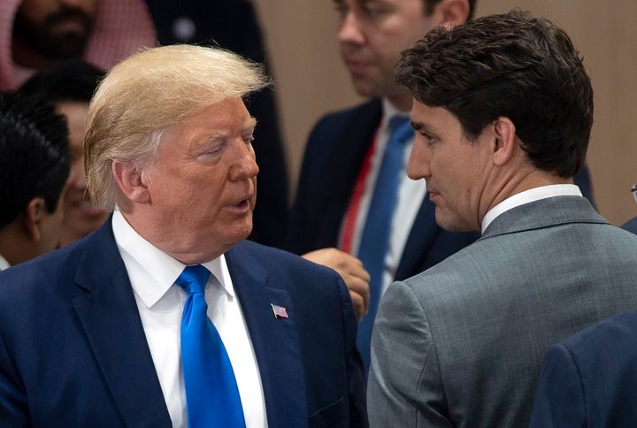 Prime Minister Justin Trudeau speaks with U.S. President Donald Trump at the start of the a plenary session at the G20 Summit in Osaka, Japan on June 29, 2019.